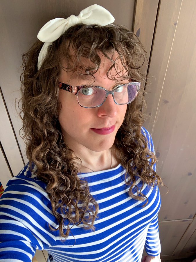 Me in a blue and white striped shirt with a white bow in my hair