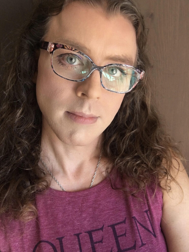 My “day one” HRT selfie. None of it looks like me, even my glasses aren’t right for the real me, and my eyes are still half dead (but also half alive for the first time). I don’t know who this chick is in this photo, but she’s not me. But I can see hints of me starting to appear in there.