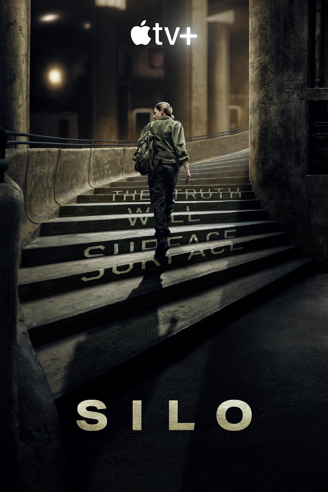 A SILO promotional poster with Rebecca Ferguson as Juliette Nichols walking up a large spiral staircase with the words “the truth will surface” on the steps. On AppleTV+.