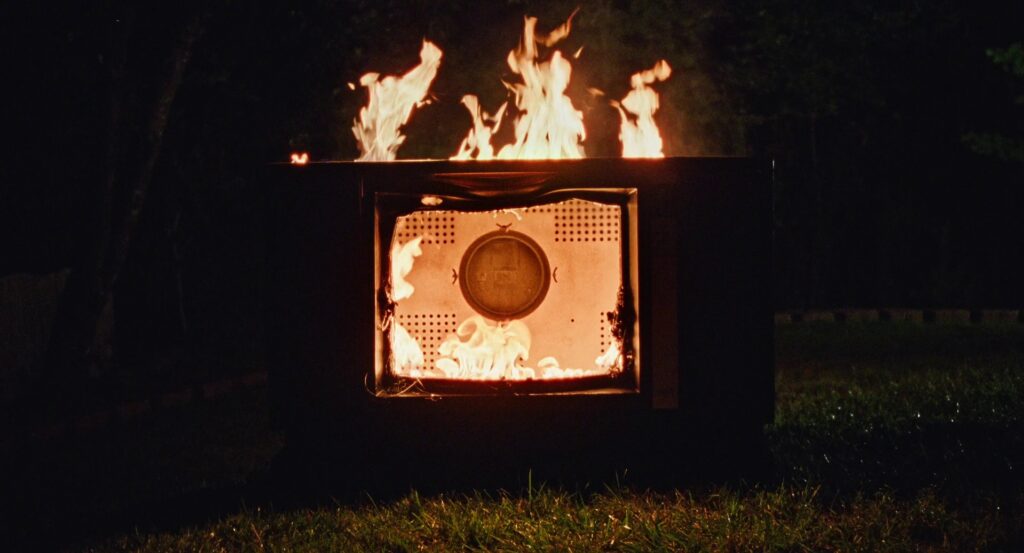 An old CRT television burning in the dark