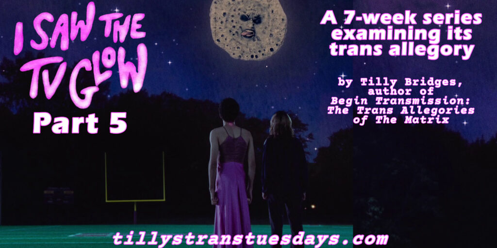 Screenshot of Owen in his pink dress, next to Maddy, on the football field, looking up at the old-timey moon face of Mr Melancholy, with superimposed text that reads "I saw the tv glow part 5, a 7-week series examining its trans allegory, by tilly bridges, author of Begin Transmission: The Trans Allegories of The Matrix" at tillystranstuesdays.com"