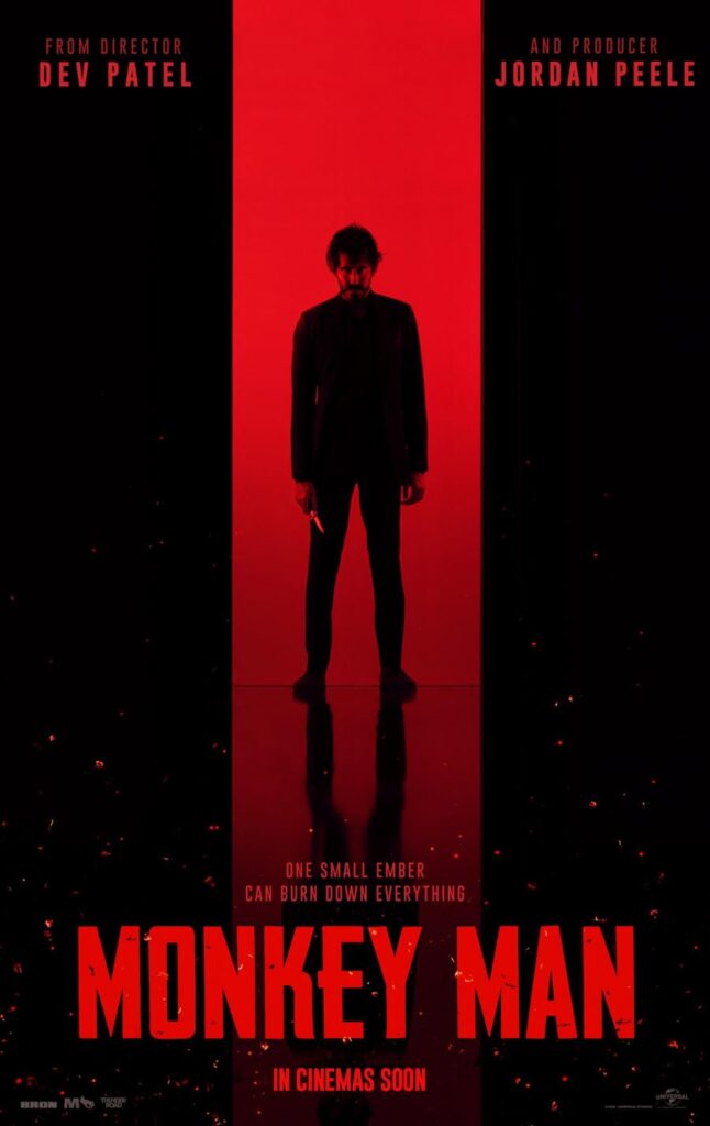 Monkey Man promo poster, showing a vertical red stripe surrounded by black. In the middle of the red stripe is Dev Patel, in a suit, holding a knife.